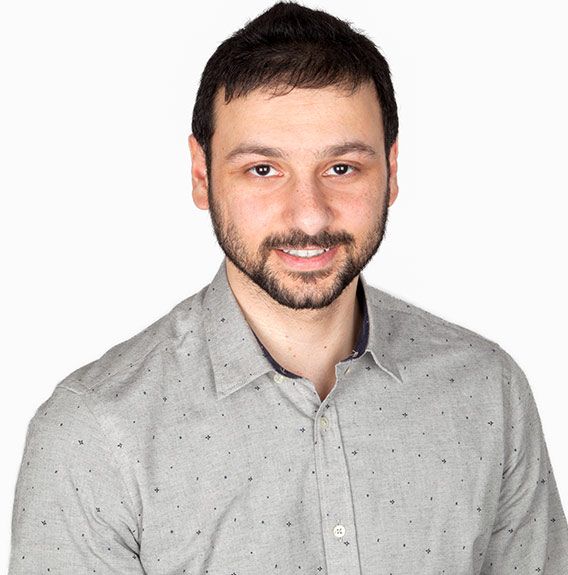 A man with a beard is wearing a grey shirt | Dr. Suman Singh