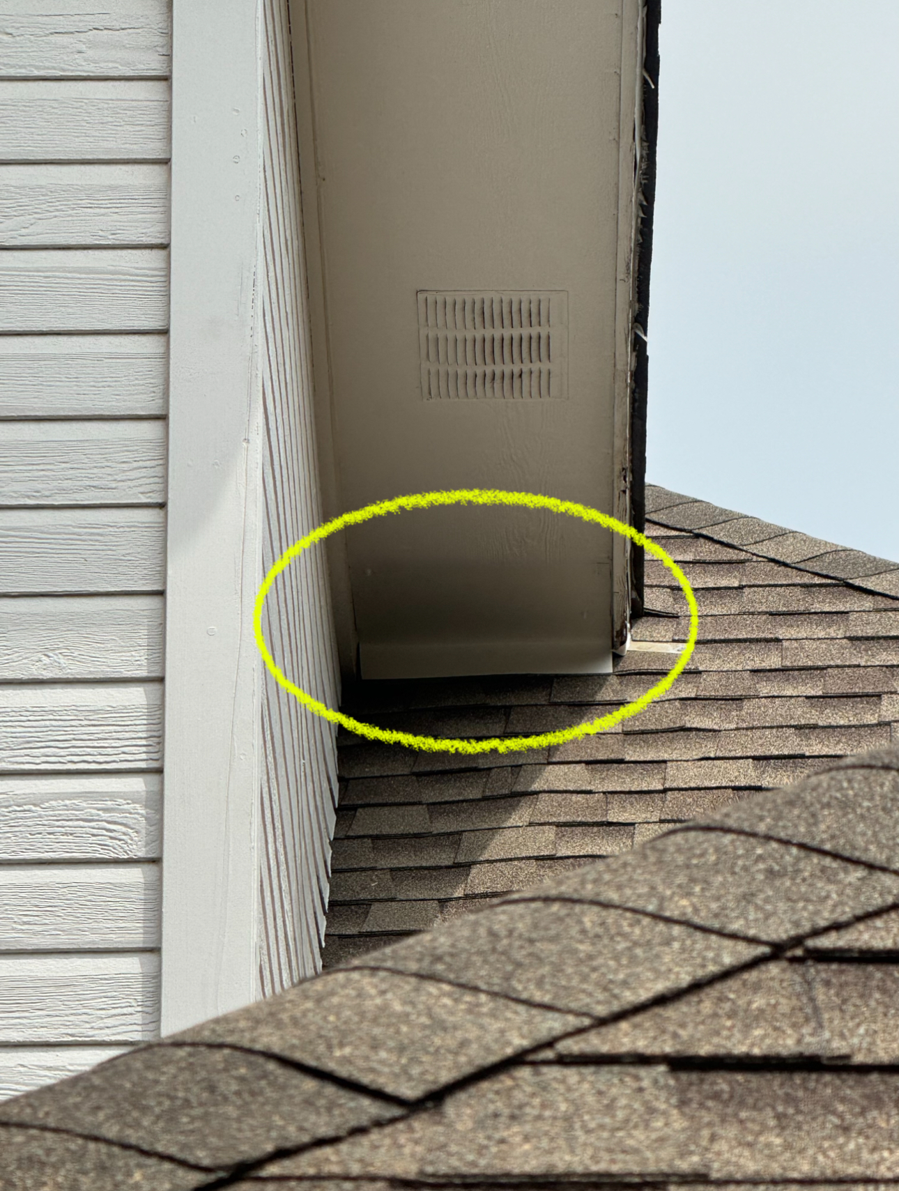 Roof and siding of a house with a vent, highlighted in yellow.