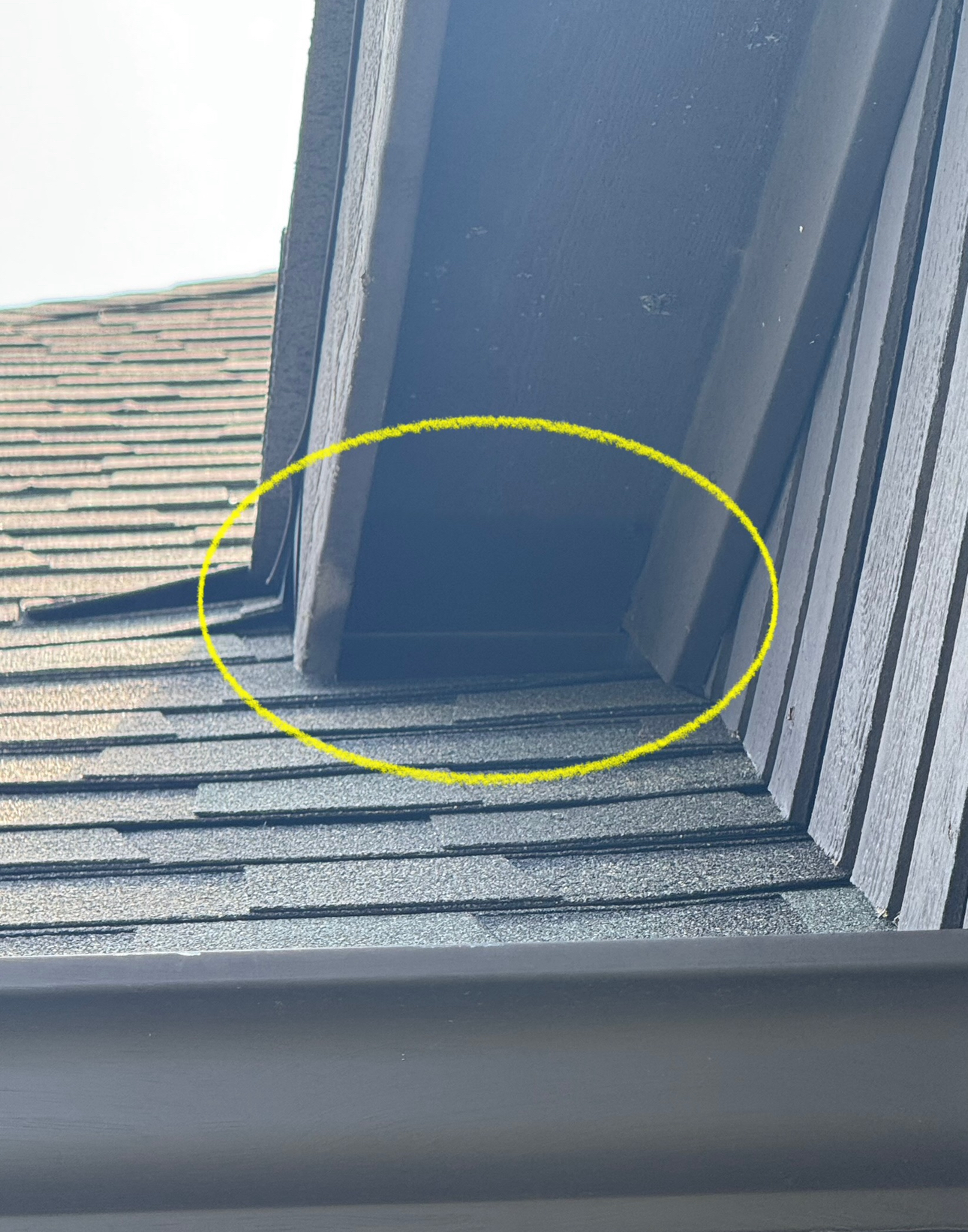 A shadowed roof overhang with wood trim, angled toward the viewer.