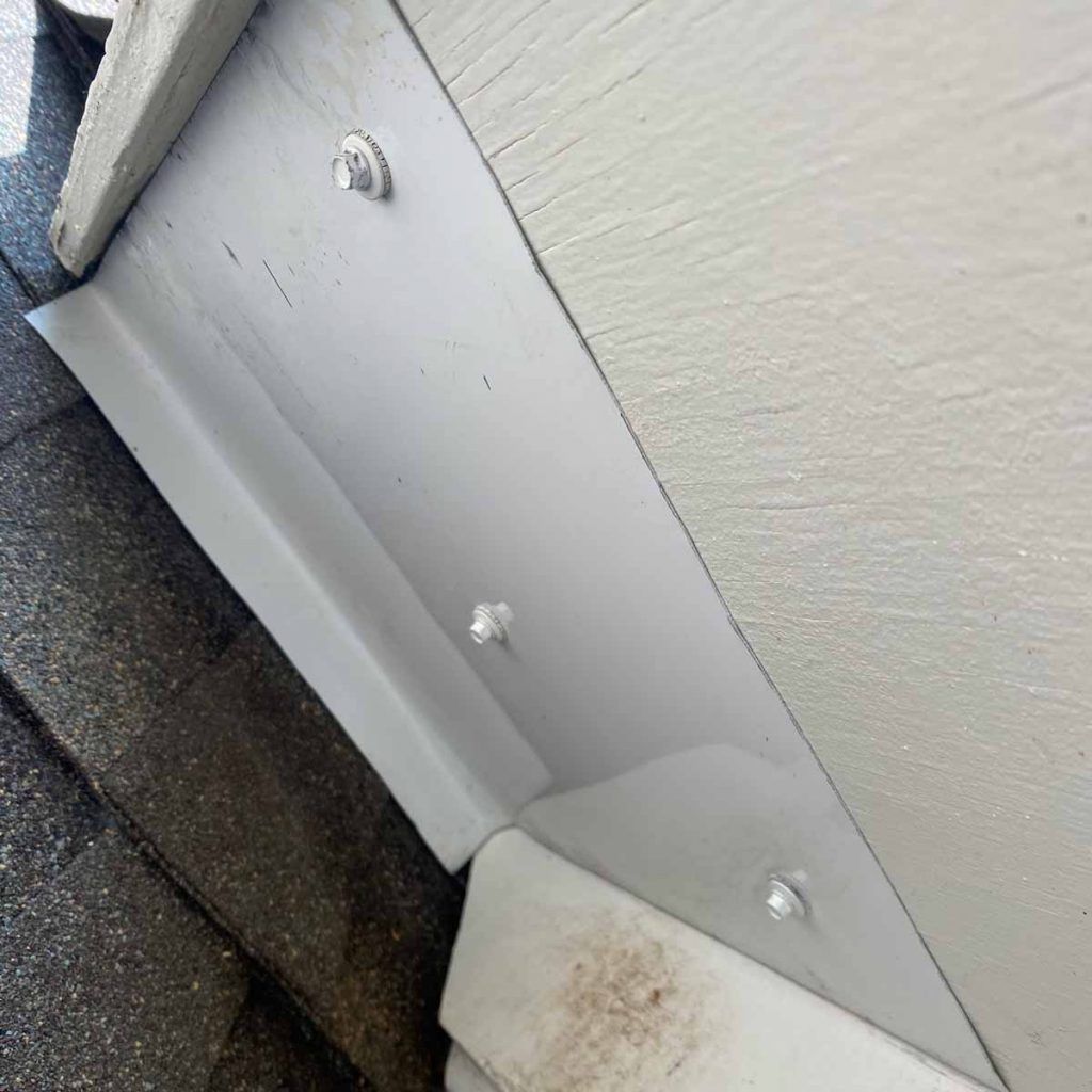 A white dresser is sitting on top of a staircase.