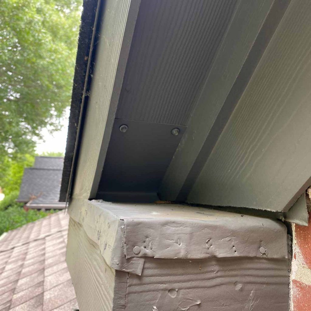 A close up of a roof gutter on a house.