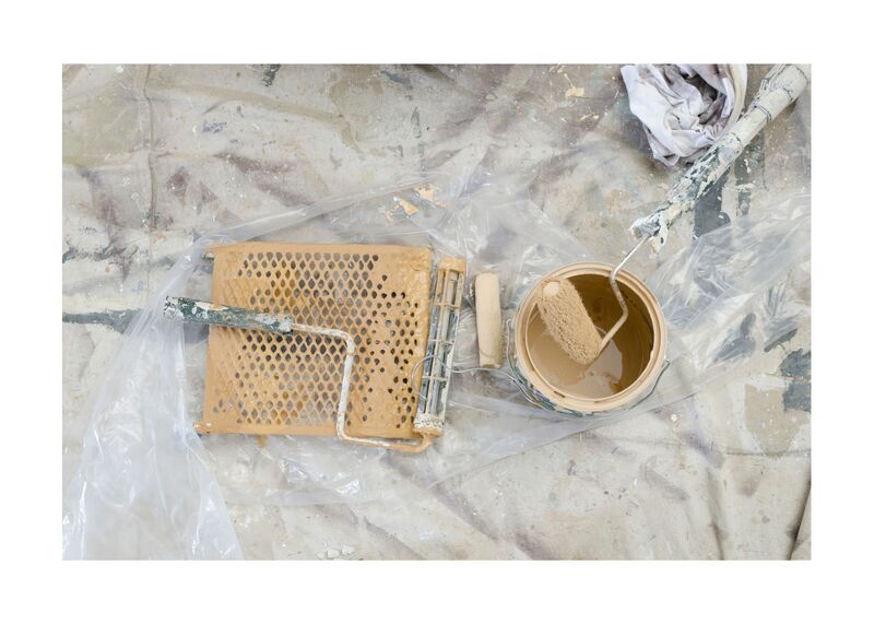 New West Painting Roller and paint can sitting on ground