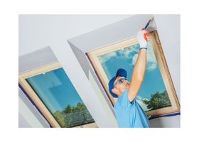 New West Painting employee painting around window trim