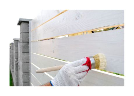 New Westminster Painting Brush coating fence with white paint