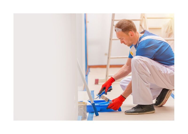 New West Painting employee in white coveralls prepping for work