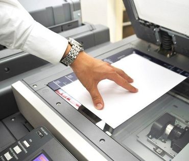 man taking a print out of a paper
