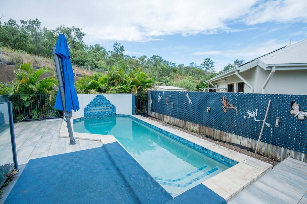 A Large Swimming Pool in the Backyard of a House — Sun City Pools In Hyde Park, QLD