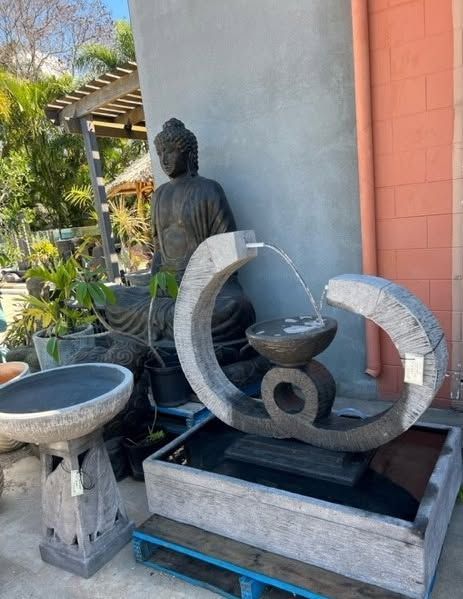 A Dark Statue Standing Beside the Fountain — Sun City Pools In Hyde Park, QLD