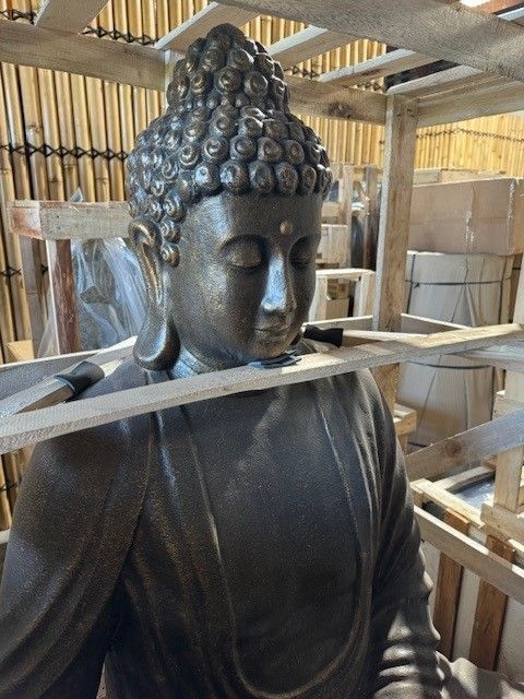 A Brown Statue Sitting Inside the Wood Fence — Sun City Pools In Hyde Park, QLD