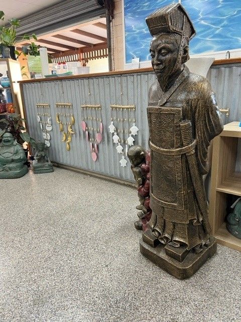 A Statue of a Man Standing in a Room Next to a Shelf — Sun City Pools In Hyde Park, QLD