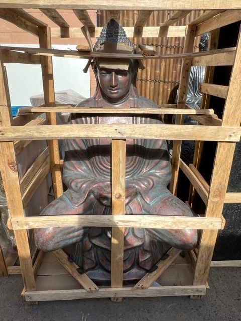 A Statue of a Man is Sitting in a Wooden Crate — Sun City Pools In Hyde Park, QLD