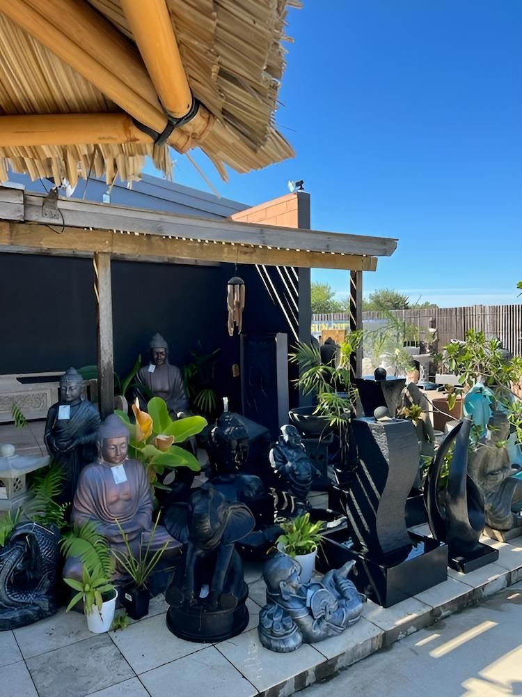 A Bunch of Statues Are Sitting Outside of a Building — Sun City Pools In Hyde Park, QLD