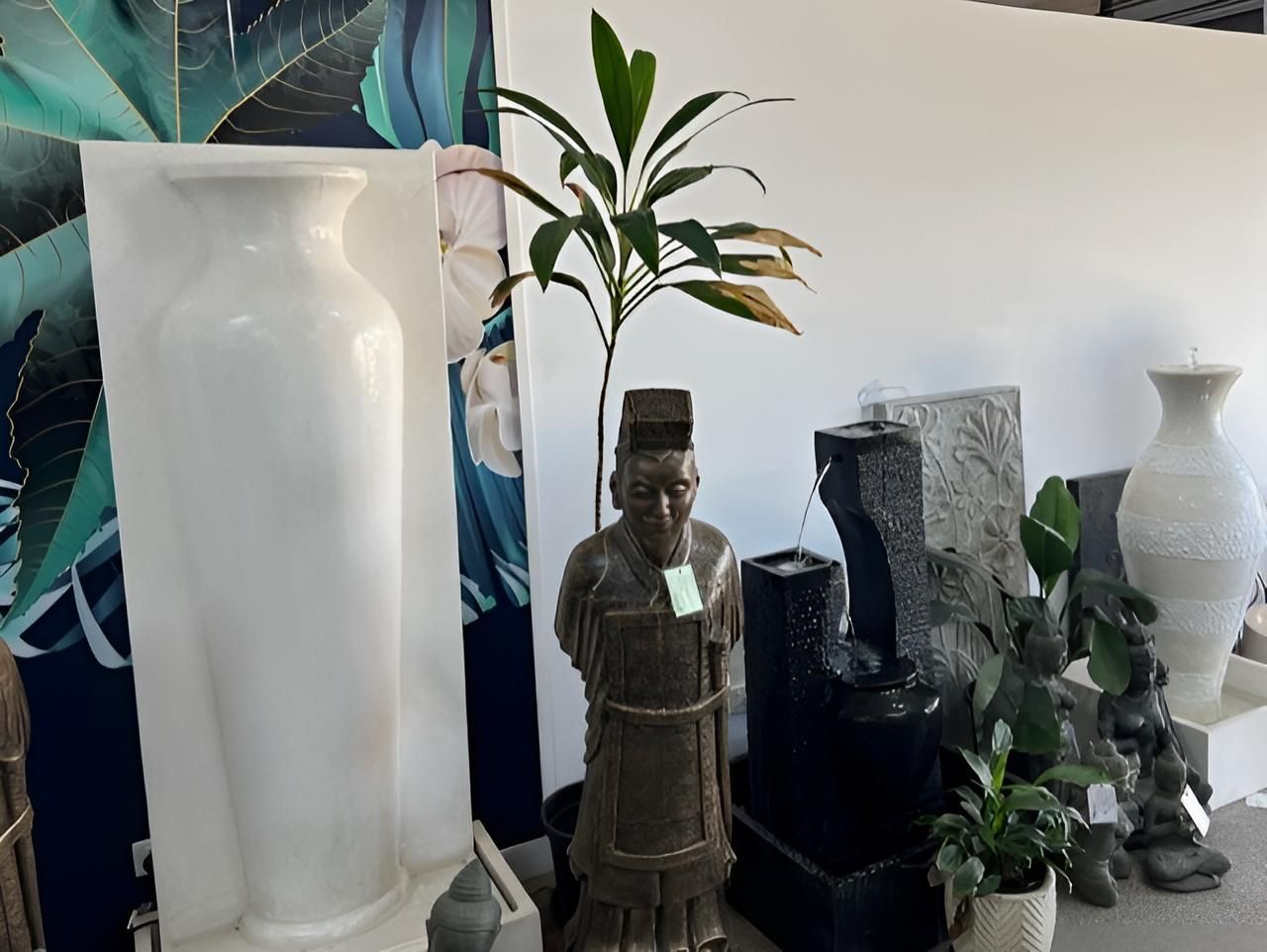 A Statue of a Man is Sitting Next to a Vase in a Room — Sun City Pools In Hyde Park, QLD