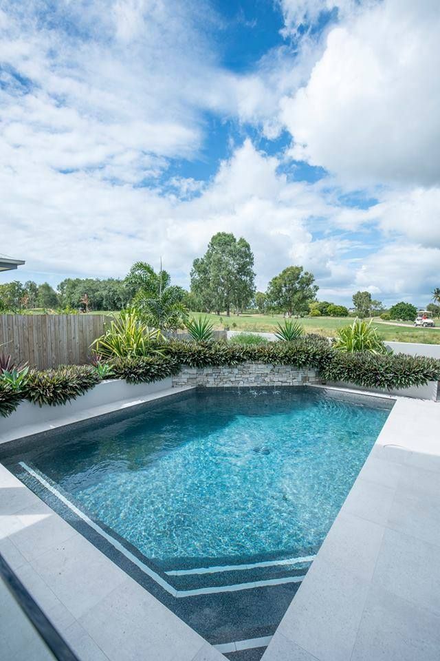 A Large Swimming Pool in the Backyard of a House — Sun City Pools In Hyde Park, QLD
