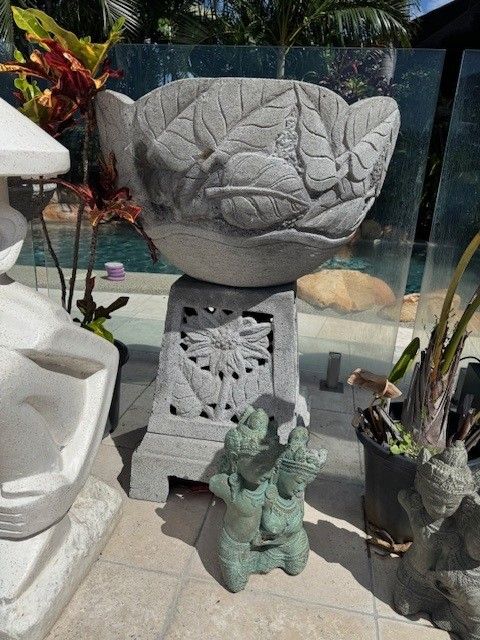 A Bird Bath and Sculpture of a Buddha Sitting on the Stone — Sun City Pools In Hyde Park, QLD