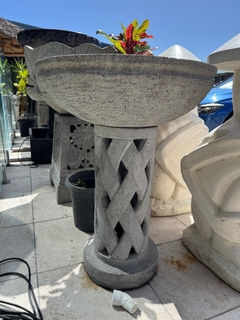 A Gray Fountain Feature With Flowing Water and Plants Background — Sun City Pools In Hyde Park, QLD