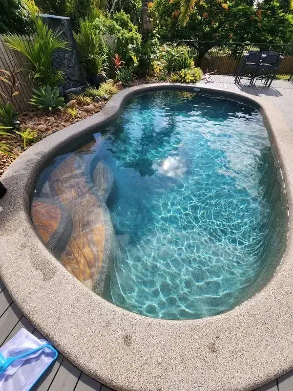 A Large Swimming Pool is Sitting on Top of a Wooden Deck — Sun City Pools In Hyde Park, QLD
