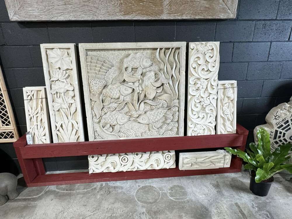 A Shelf With a Lot of Carvings on It and a Plant — Sun City Pools In Hyde Park, QLD