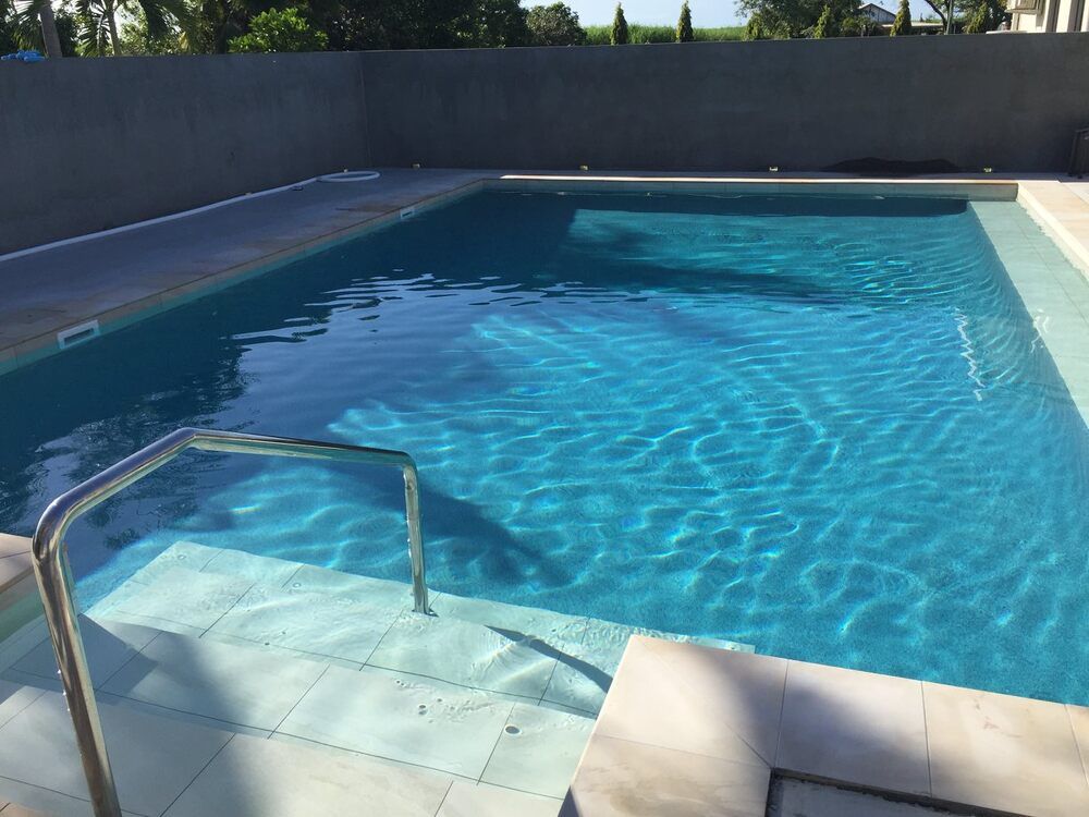 A Large Swimming Pool With a Staircase Leading to It — Sun City Pools In Magnetic Island, QLD
