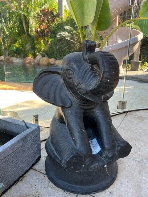 A Statue of an Elephant is Behind a Wooden Fence — Sun City Pools In Hyde Park, QLD