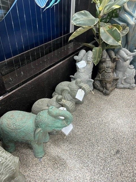 A Row of Statues of Elephants Are Sitting on the Ground — Sun City Pools In Hyde Park, QLD