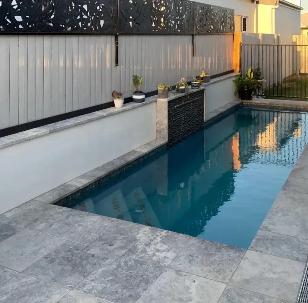 A Large Swimming Pool With a Fence Surrounding It — Sun City Pools In Hyde Park, QLD
