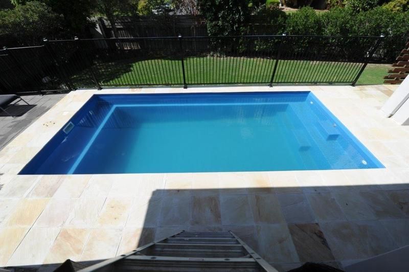 A Swimming Pool With Stairs Leading Up to It — Sun City Pools In Hyde Park, QLD