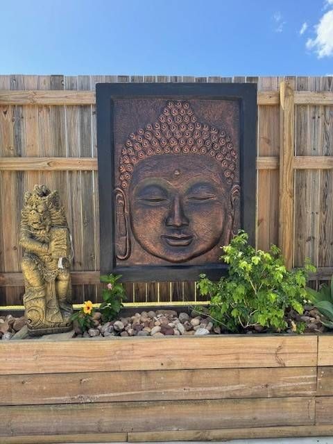 Balinese Wall décor In the Garden with a Buddha Statue — Sun City Pools In Hyde Park, QLD