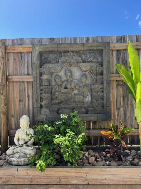 Balinese Wall décor In the Garden with a Buddha Statue — Sun City Pools In Hyde Park, QLD