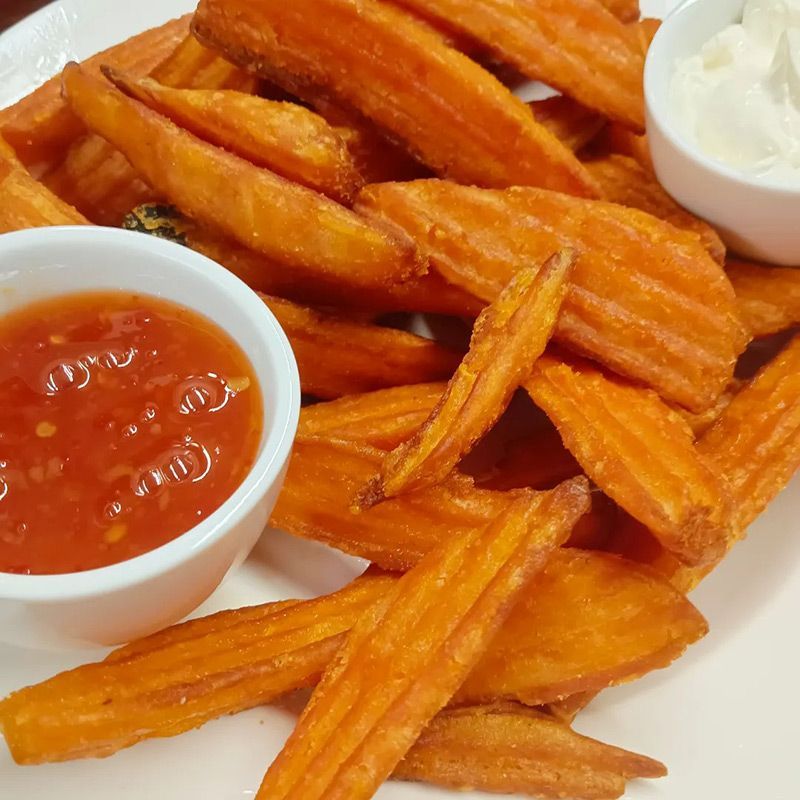 White Plate Topped With French Fries and a Small Bowl of Sauce — Heritage Resort in Nanum, QLD
