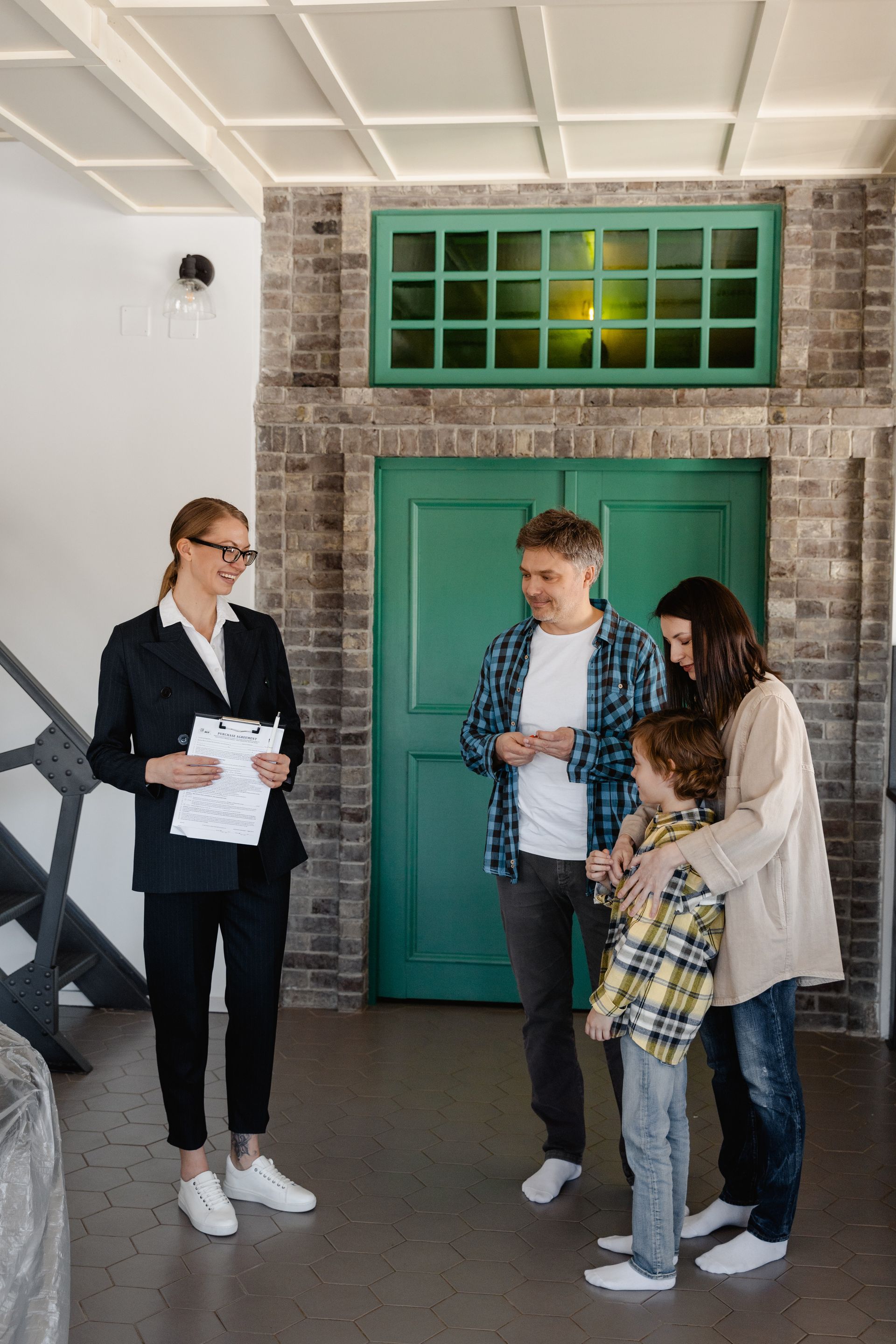A woman is talking to a family in a living room.