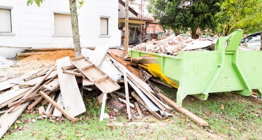 a house with a lot of trash in front of it .