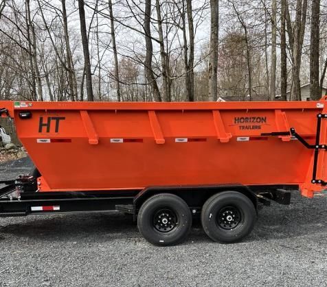 a red dumpster and a blue dumpster are sitting next to each other in a parking lot .