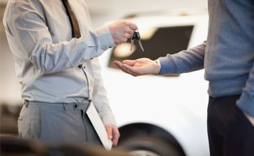 Man giving keys to another man —  Car Rental in Kingston,NY