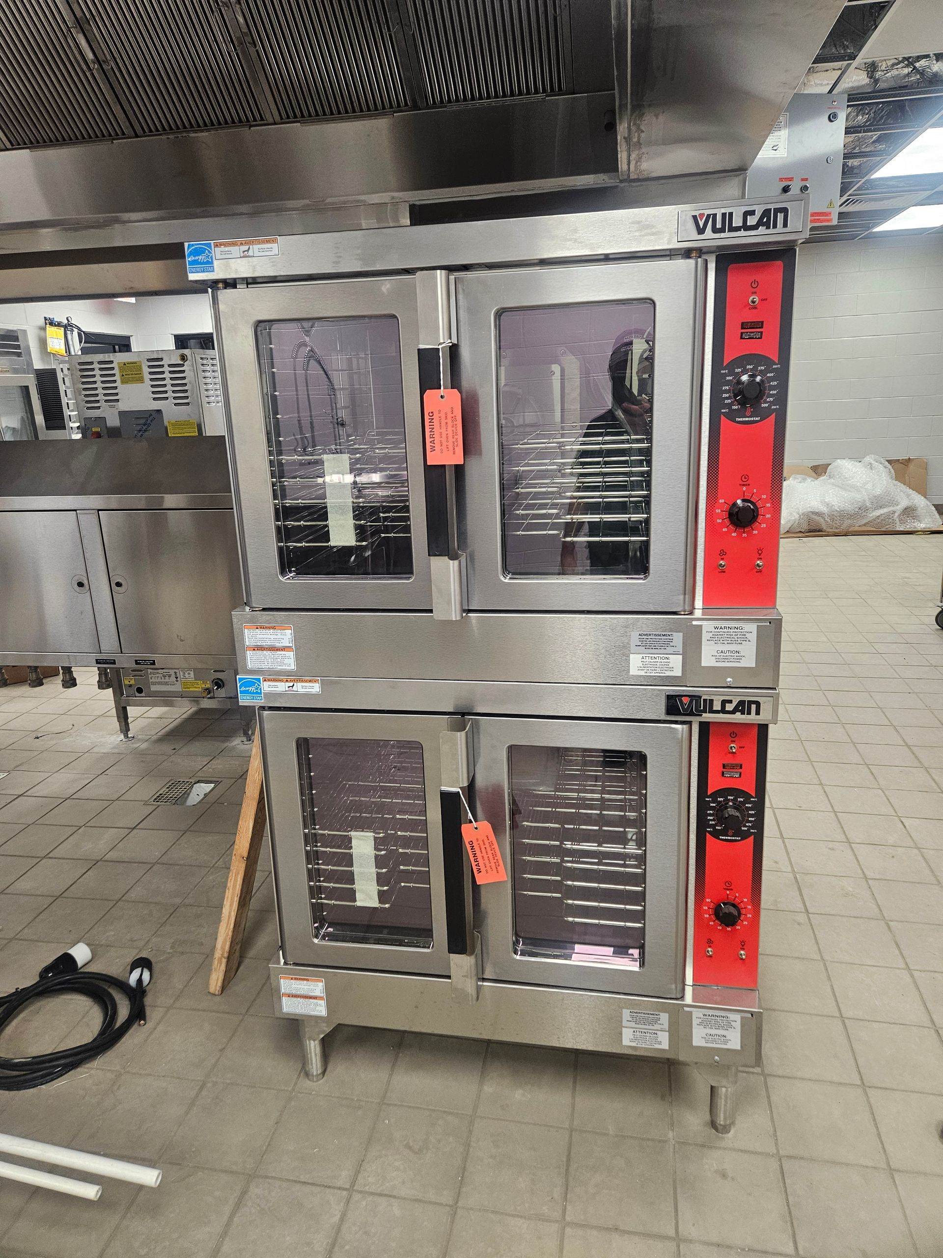 A stainless steel Vulcan commercial oven, two stacked sections, red controls, in a kitchen.
