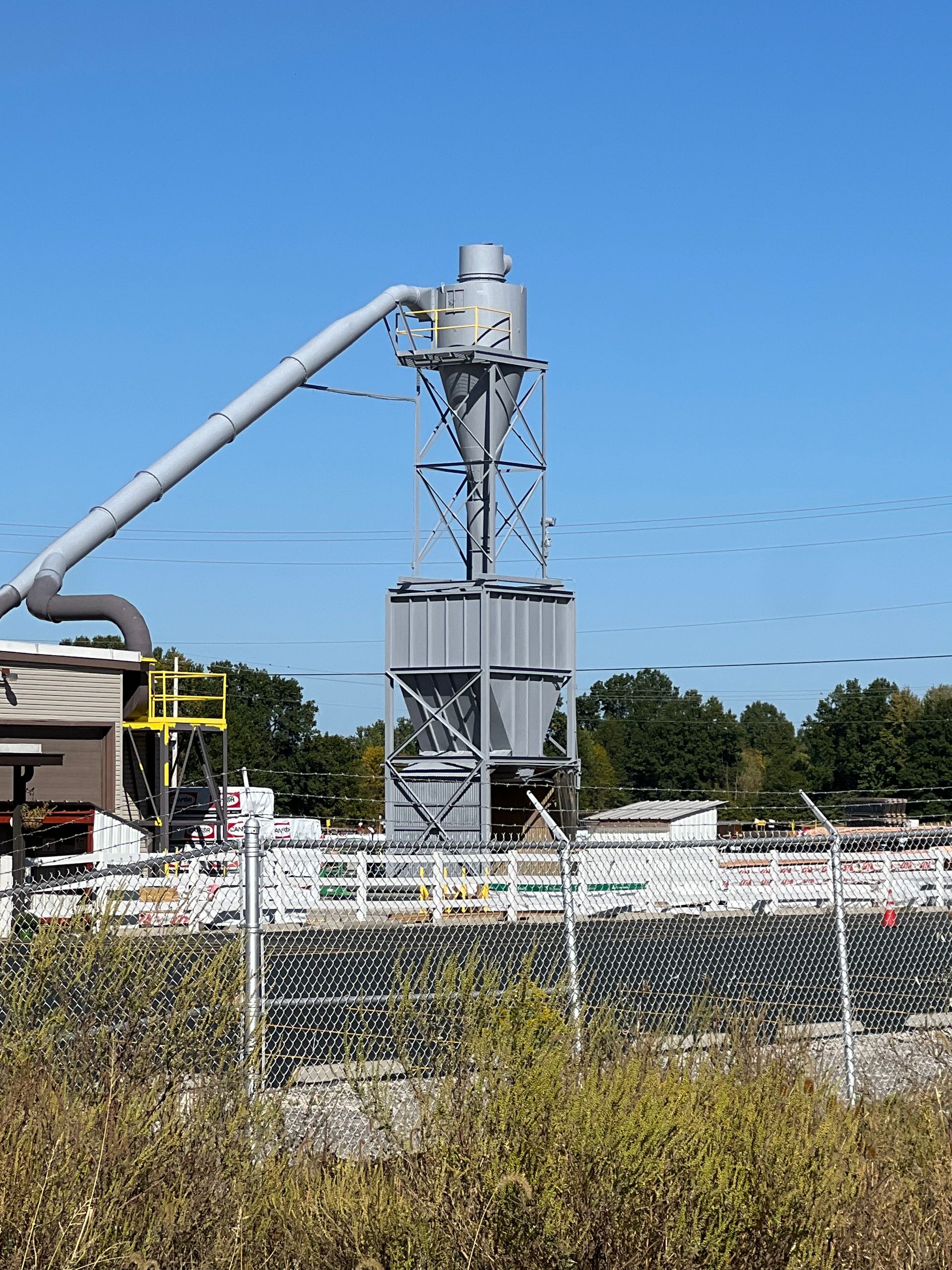 A large machine is sitting in the middle of a field.