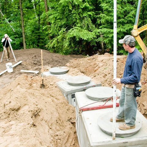 Septic Cleaning — Man Cleaning Septic Tank in Miramar, FL