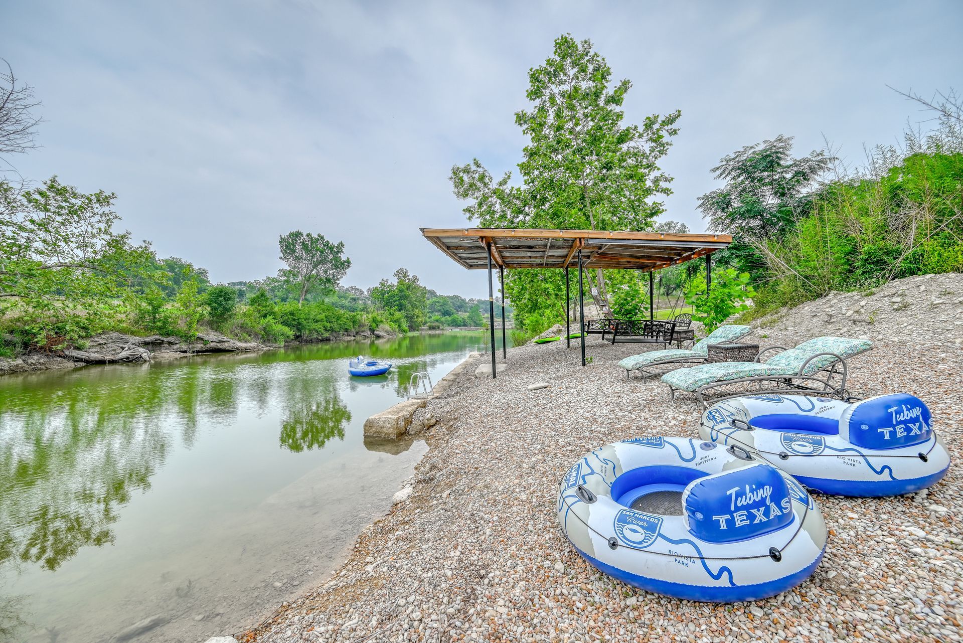 Two rafts are sitting on the shore of a lake.