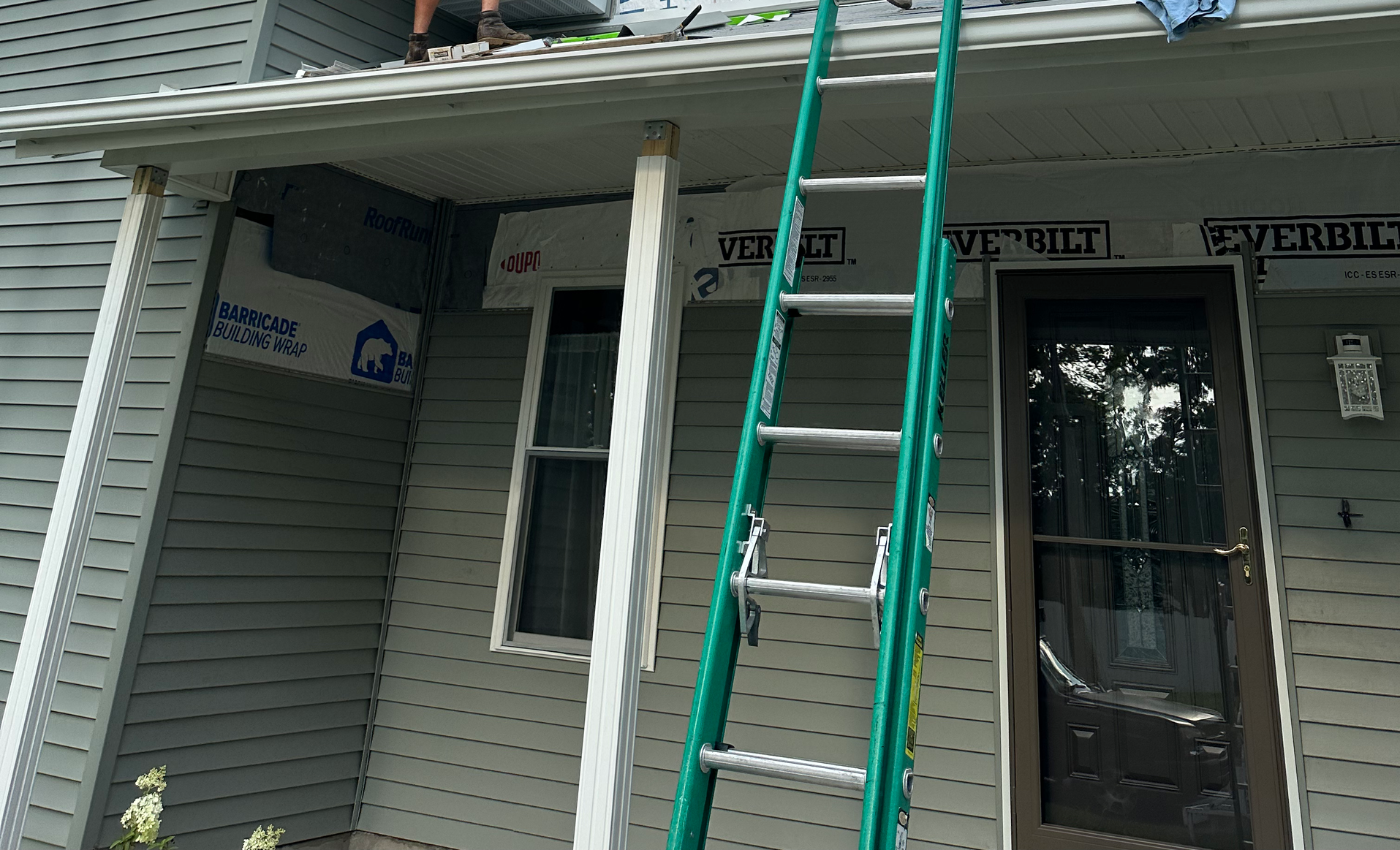 Door Installation — Man Installing Sliding Glass Door in Syracuse, IN