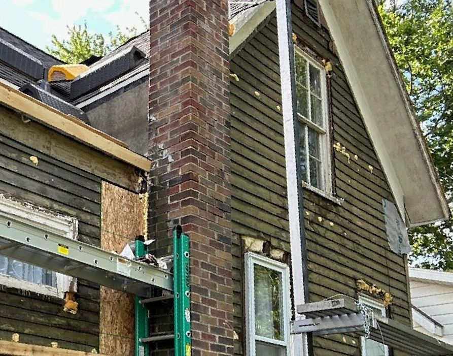 Insulation Installation — Man Installing Roof Insulation Layer in Syracuse, IN