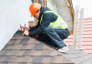 Roofing Contractors — Roofer Repairing Shingles Roof in Syracuse, IN