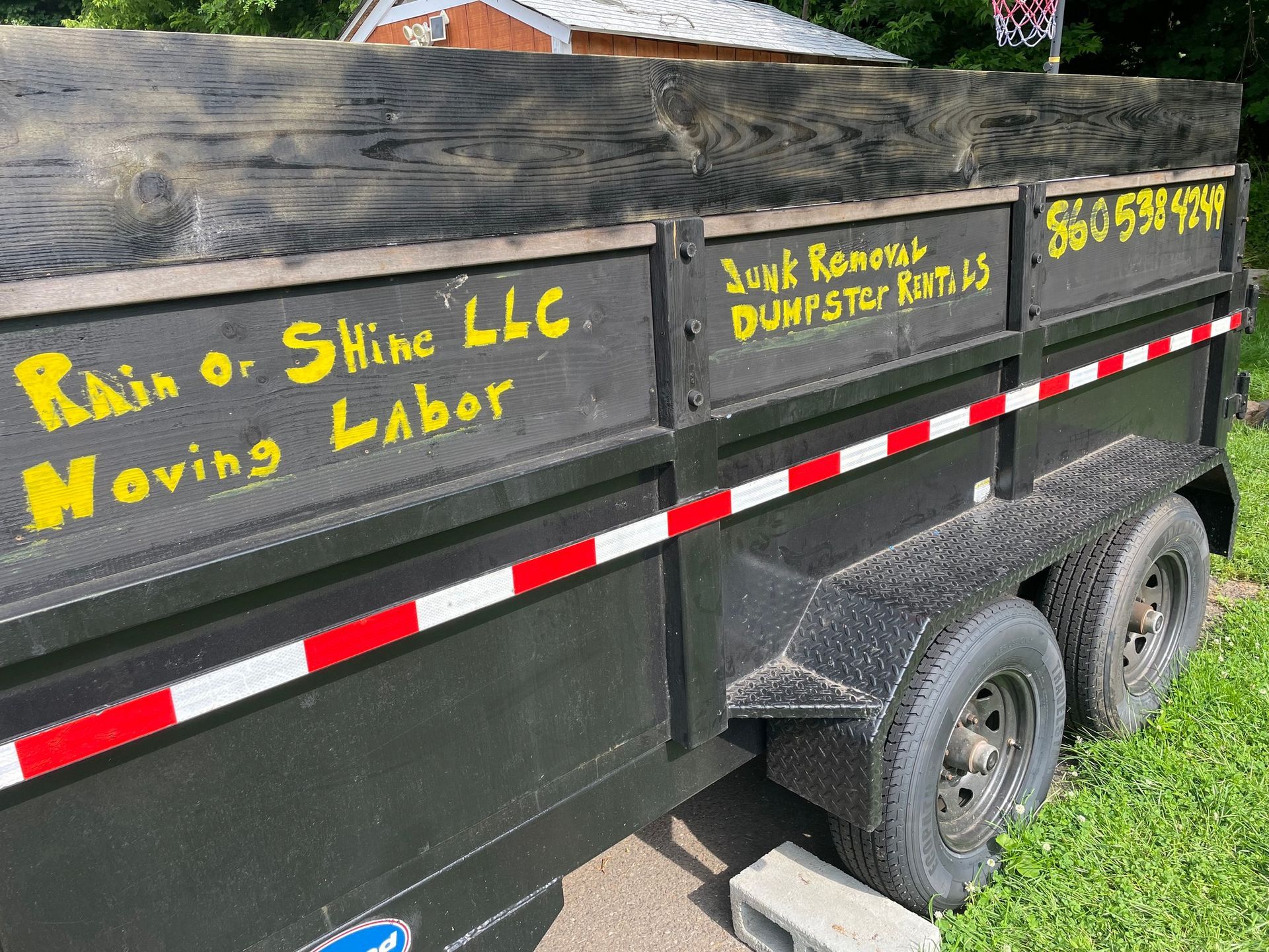 Black trailer with yellow text: