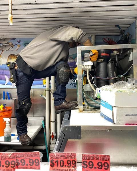 A man is working on a machine with a price tag that says 9.99