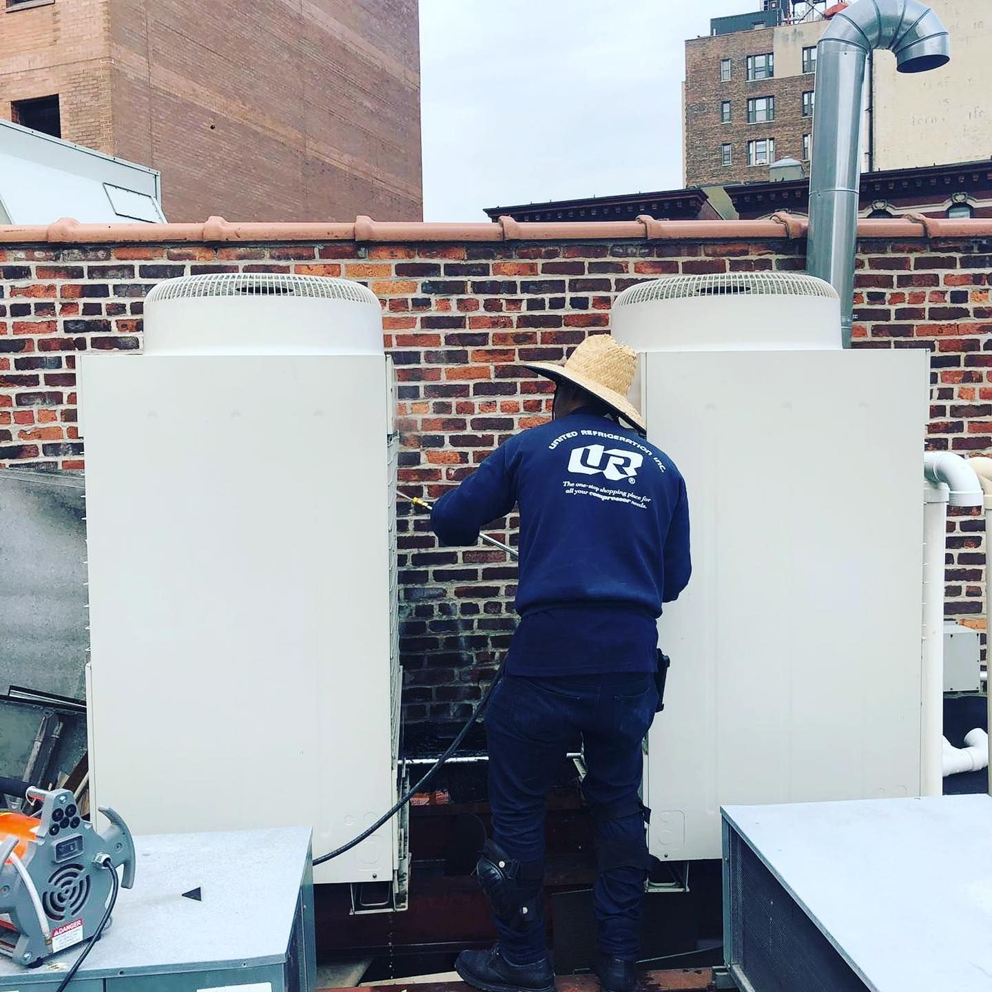 A man wearing a hat and a blue shirt with the word da on the back