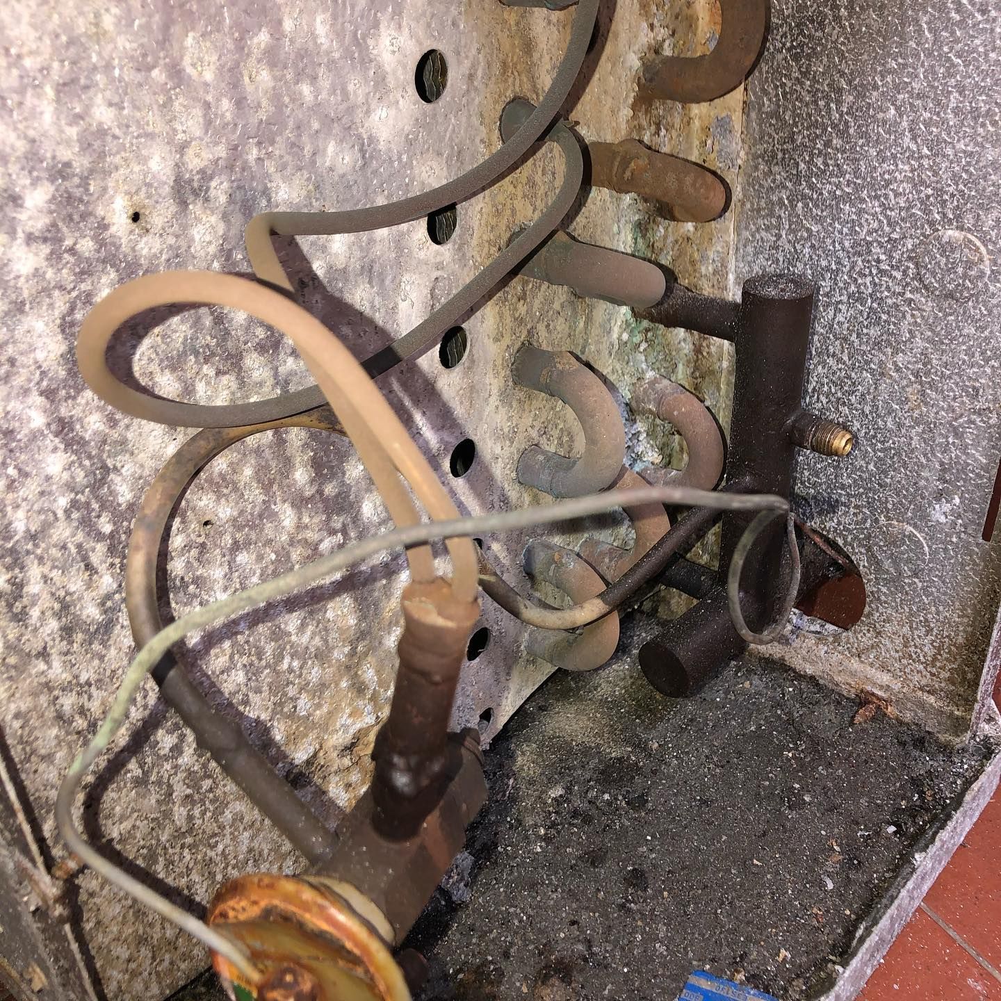 A bunch of wires are hanging off of a wall