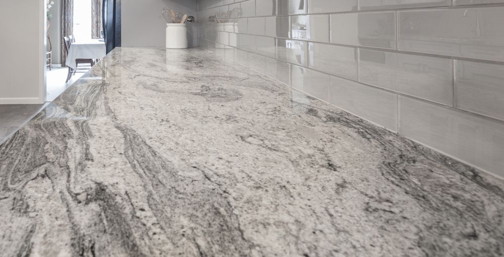 A close up of a granite counter top in a kitchen.