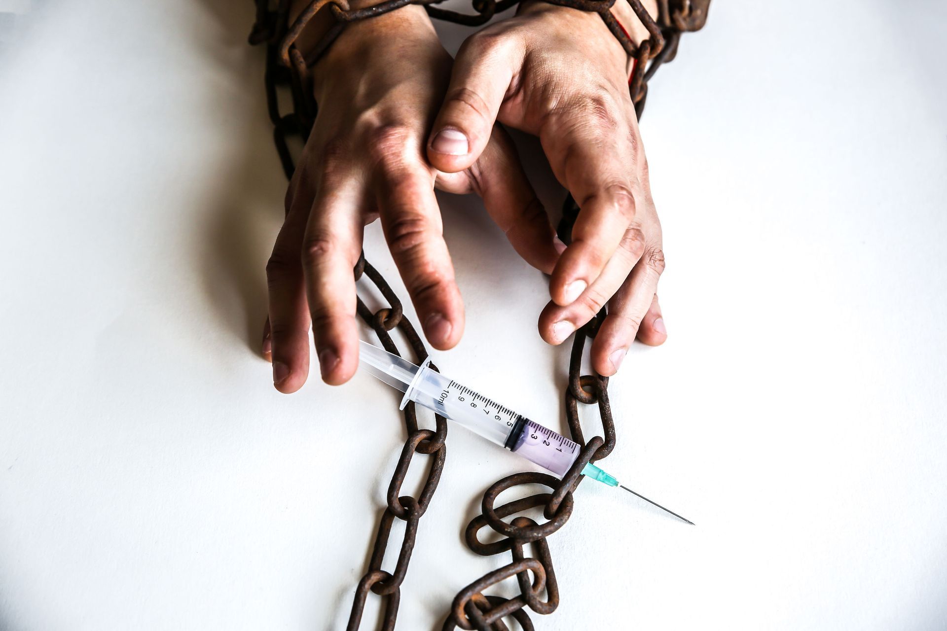 Handcuffed man with syringe