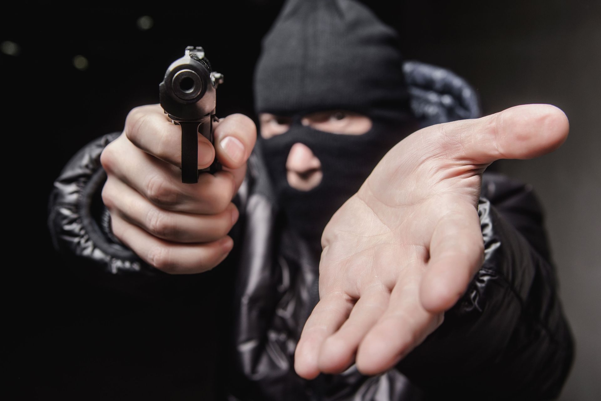 Robber aiming a gun