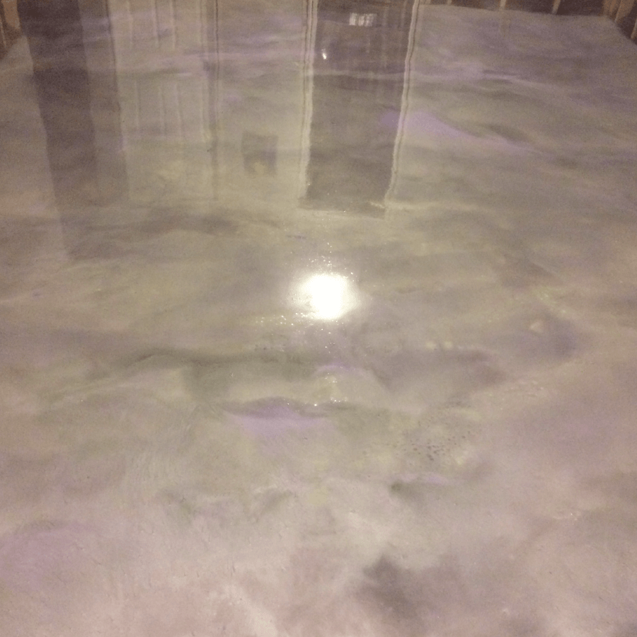 A close up of a shiny concrete floor in a room.