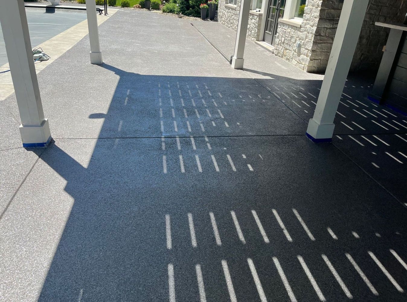 A shadow of a person is cast on a concrete surface.